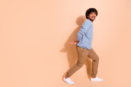 Full size photo of suffering crying guy dressed blue pullover trousers pull heavy object empty space isolated on pastel color backgroundの写真素材