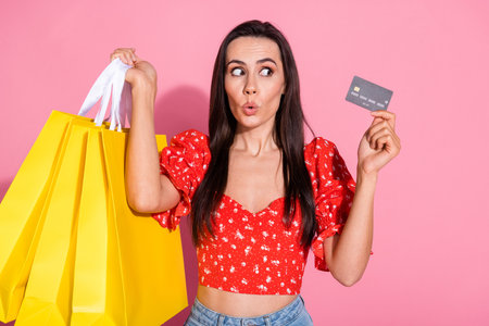 Photo of pretty young woman credit card shop bags wear top isolated on pink color background