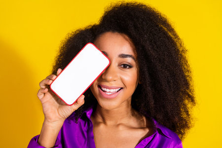 Photo portrait of attractive young woman hold device cover white screen dressed stylish violet...