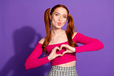 Photo portrait of pretty young girl show heart gesture kissing wear trendy pink outfit isolated on...