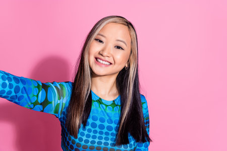 Photo of shiny attractive lady dressed print shirt tacking selfie empty space isolated pink color backgroundの写真素材