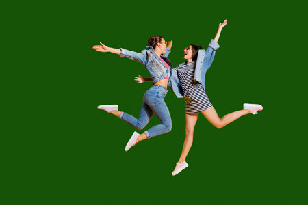 Full legs body size portrait of two sweet gorgeous glad positive nice adorable good-looking lady in...