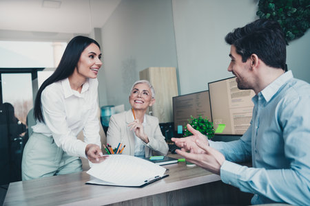 Photo of three business people have discussion in modern office analyze statisticsの写真素材