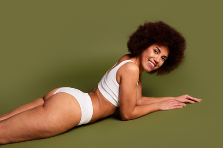 No filter photo of cheerful pretty lady underwear lingerie enjoying girls power isolated khaki color backgroundの写真素材