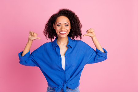 Photo of charming adorable woman wear blue stylish clothes showing her outfit isolated on pink color backgroundの写真素材