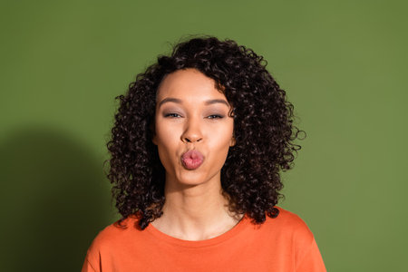 Photo portrait of attractive young woman kissing lips romantic dressed stylish orange clothes...