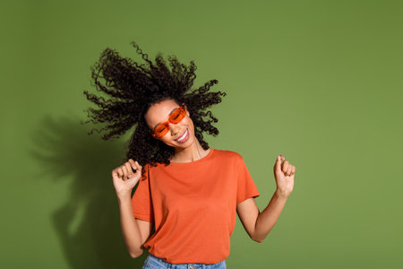 Photo portrait of attractive young woman sunglass dancing enjoy music dressed stylish orange clothes...