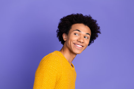 Photo of cheerful positive man wear stylish yellow clothes look empty space isolated on purple color...