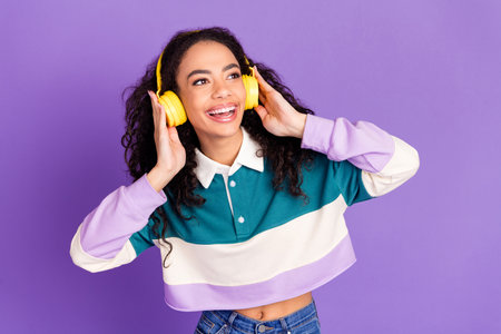 Portrait of lovely young girl look empty space wear shirt isolated on purple color background