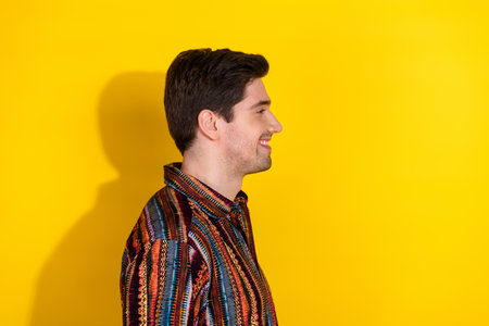 Profile photo of nice young man look empty space wear shirt isolated on yellow color background