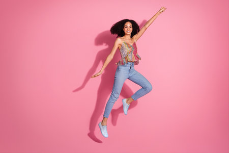 Full body photo of attractive young woman flying dressed stylish sequins clothes isolated on pink...