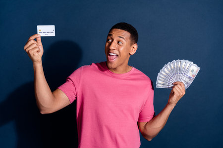Photo portrait of young ambitious and successful businessman investing his money for future isolated...