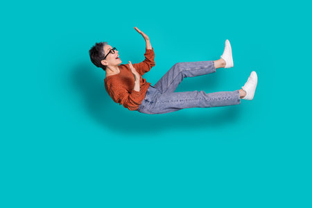 Full body photo of attractive senior woman falling flying have fun dressed stylish brown clothes...