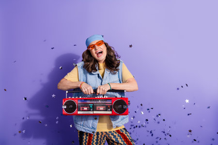 Photo portrait of lovely pensioner lady celebrate hold boombox dressed stylish denim hipster garment...