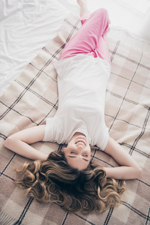 Top photo of positive girl sleeping comfort lying bed in morning roomの写真素材
