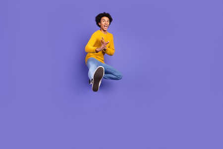 Photo of positive cheerful man wear stylish yellow clothes isolated on purple color backgroundの写真素材