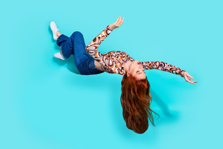 Full length photo of lovely young lady fly hang upside down amazed dressed stylish colorful garment...