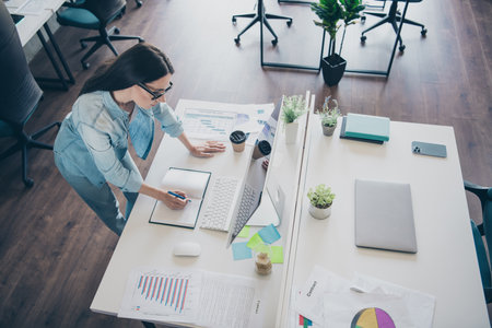 Photo portrait of pretty young girl online webinar make notes wear trendy denim outfit modern workplace success business owner home officeの写真素材