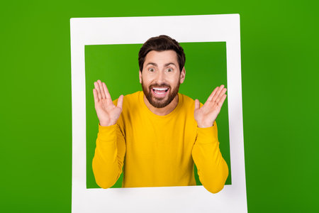 Photo portrait of handsome young guy amazed instant photo frame dressed stylish yellow garment...