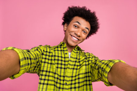 Photo of nice young man make selfie toothy smile wear shirt isolated on pink color backgroundの写真素材