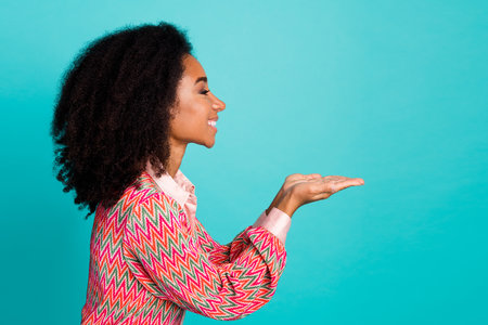 Photo of shiny attractive lady dressed print blouse showing arms empty space isolated teal color backgroundの写真素材