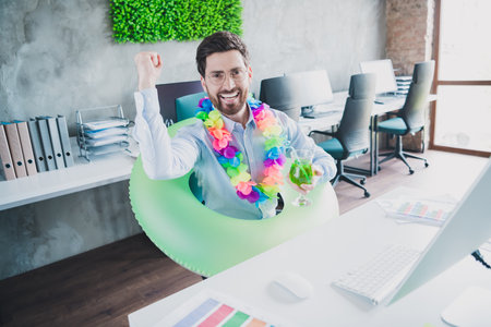 Photo of successful elegant man raise fist cocktail vacation rest wear shirt loft interior modern office indoorsの写真素材