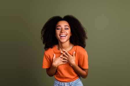 Photo of charming positive woman wear orange t-shirt laughing empty space isolated khaki color...