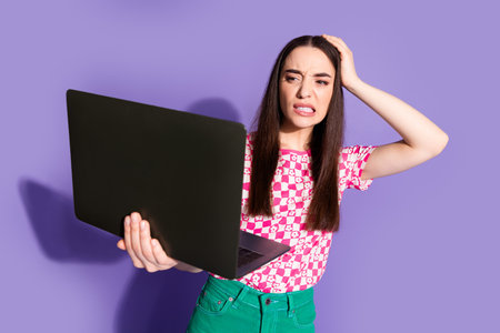 Photo portrait of pretty young girl hold netbook nervous mistake wear trendy pink outfit isolated on...