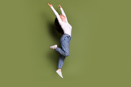 Full body photo of attractive young woman dance jump raise hands dressed stylish white clothes...