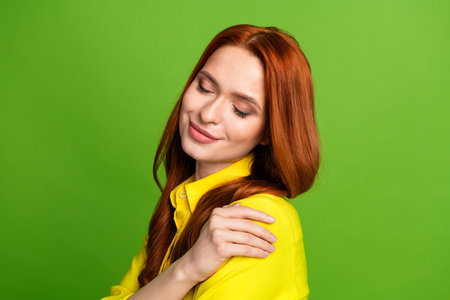 Photo of charming lovely cute woman wear yellow trendy clothes hug herself isolated on green color...