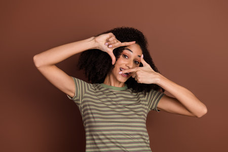 Photo of adorable lovely girl wear khaki t-shirt showing arms photo empty space isolated brown color...