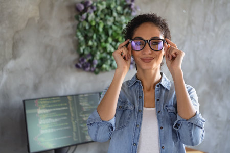 Photo of young girl professional hacker hands touch glasses loft interior modern office indoorsの写真素材