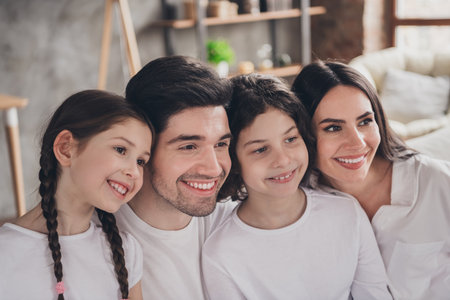 Photo of pretty cheerful boyfriend girlfriend kids wear casual looks smiling hugging indoors room home houseの写真素材