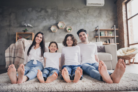 Photo of adorable charming mom dad children wear casual outfits spending time together indoors room home houseの写真素材