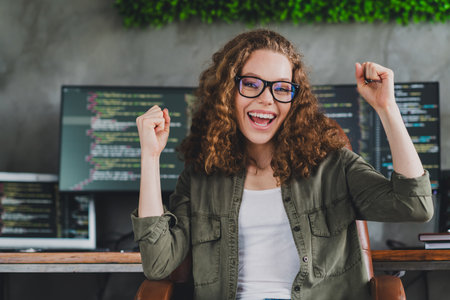 Photo of lovely excited glad woman software developer sitting armchair comfortable workspace...