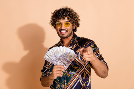 Photo portrait of attractive young man hold money fan point you dressed stylish print clothes...