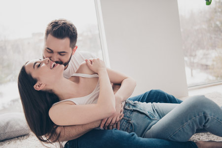Photo of happy young couple move new place enjoy live together hugging lying floor have fun new...