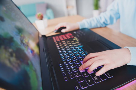 Cropped photo of addicted user little gamer playing online video game indoors houseの写真素材