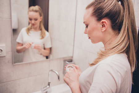 Photo of adorable sweet lady slepwear smiling enjoying skin care procedures bathroom home houseの写真素材