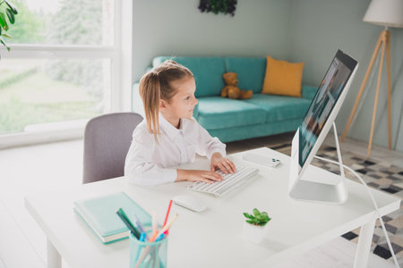 Photo portrait of cute adorable girl browsing typing online computer remote lesson education from...