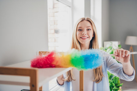 Photo of adorable sweet young lady wear blue shirt enjoying daily cleaning indoors room home house