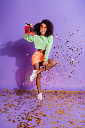 Photo portrait of american young cheerful funny woman wearing green stylish top boombox dj isolated...