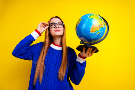Photo portrait of pretty young girl hold globe geography teacher wear trendy blue knitwear outfit...