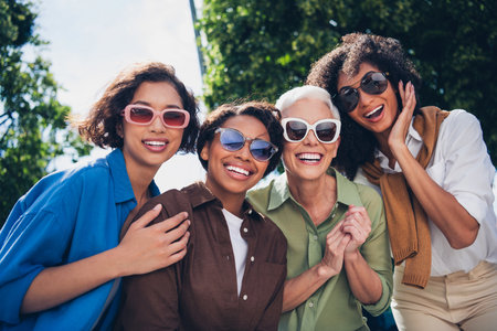 Photo of company friends women laugh good mood free time chill walk city park outdoorsの写真素材