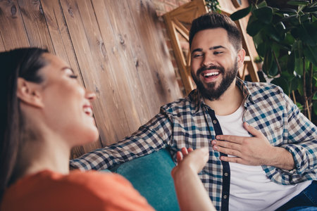Photo of happy cheerful optimistic charming people laughing speaking in cafe comfort interior indoorsの写真素材