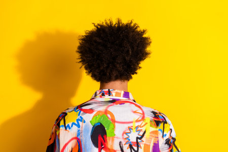 Rear behind photo of nice young man hairdo wear shirt isolated on bright yellow color backgroundの写真素材