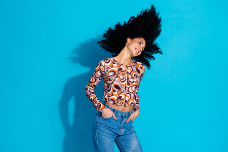 Photo of charming glad cheerful woman wear stylish print clothes empty space isolated on blue color...
