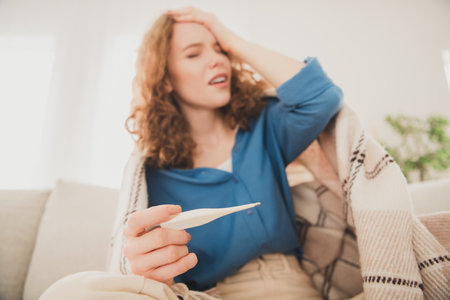 Photo of cheerful young girl headache touch forehead high temperature blue shirt weekend apartment...