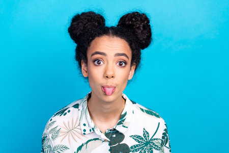 Portrait of lovely young girl show tongue wear shirt isolated on blue color background