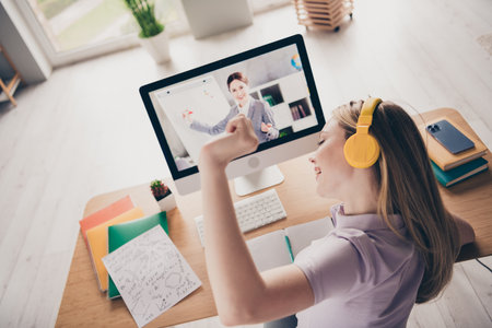 Photo of adorable carefree lady wear purple polo headphones online education modern device indoors room home houseの写真素材